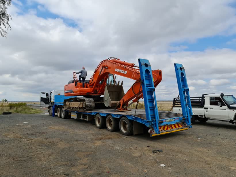 Excavator loaded on a lowbed trailer
