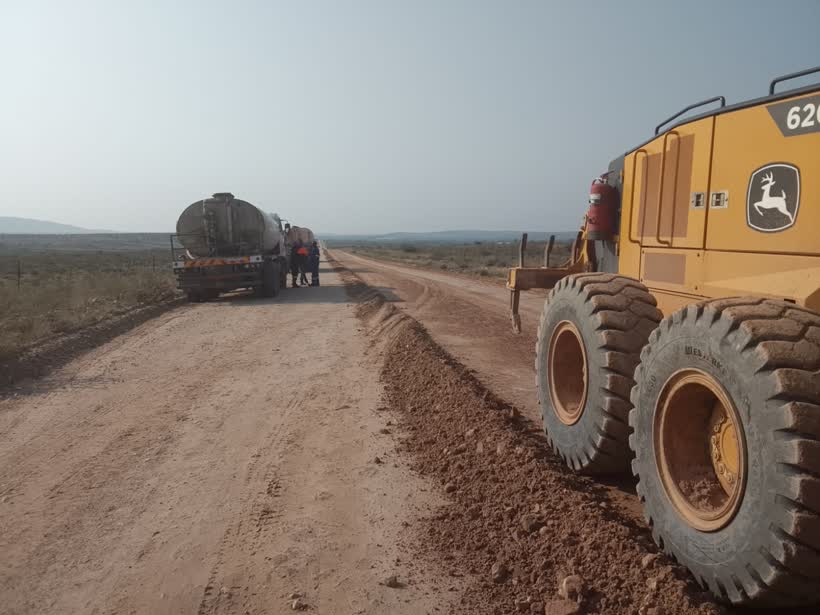 Grader and water tanker on a road maintenance project