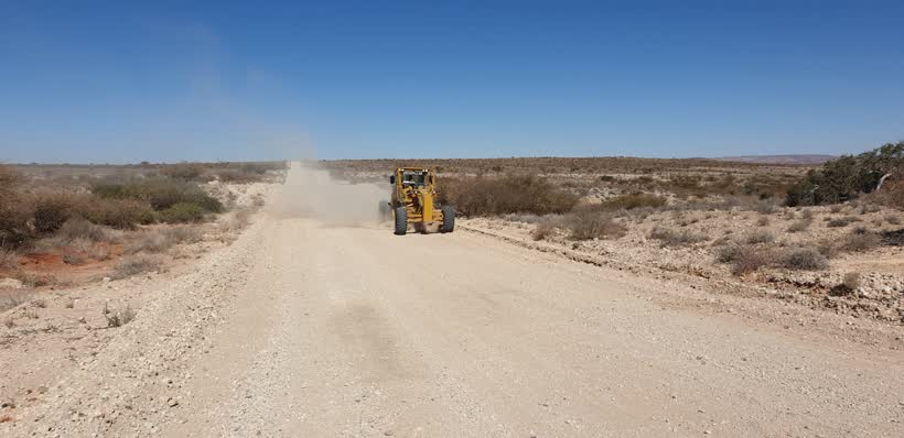 Motor grader building a gravel road